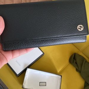 New With tags black Authentic Gucci wallet. Box and bag included.